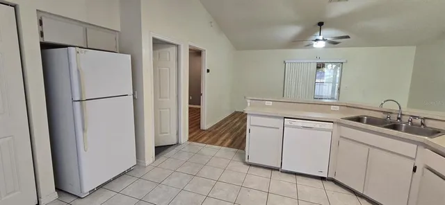 a kitchen with a refrigerator and a sink