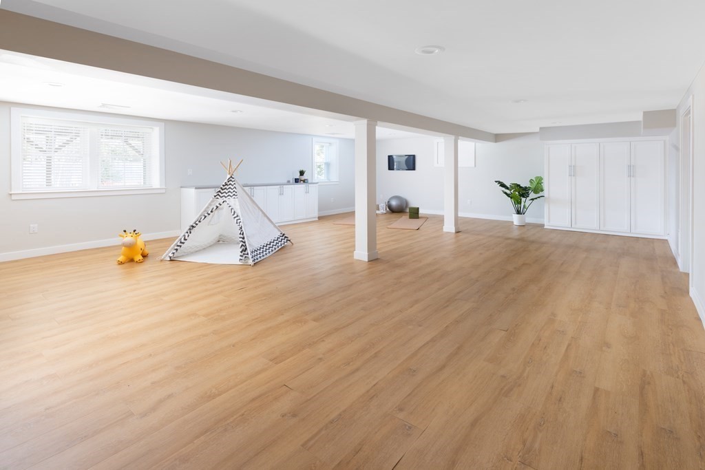 34 Fairbanks Road Lexington, MA 02421 - Photo 19 of 36 a room with wooden floor and white walls