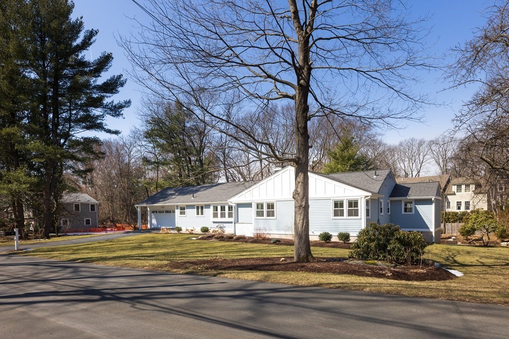 34 Fairbanks Road Lexington, MA 02421 - Photo 26 of 36 a view of a white house with a large tree next to a yard