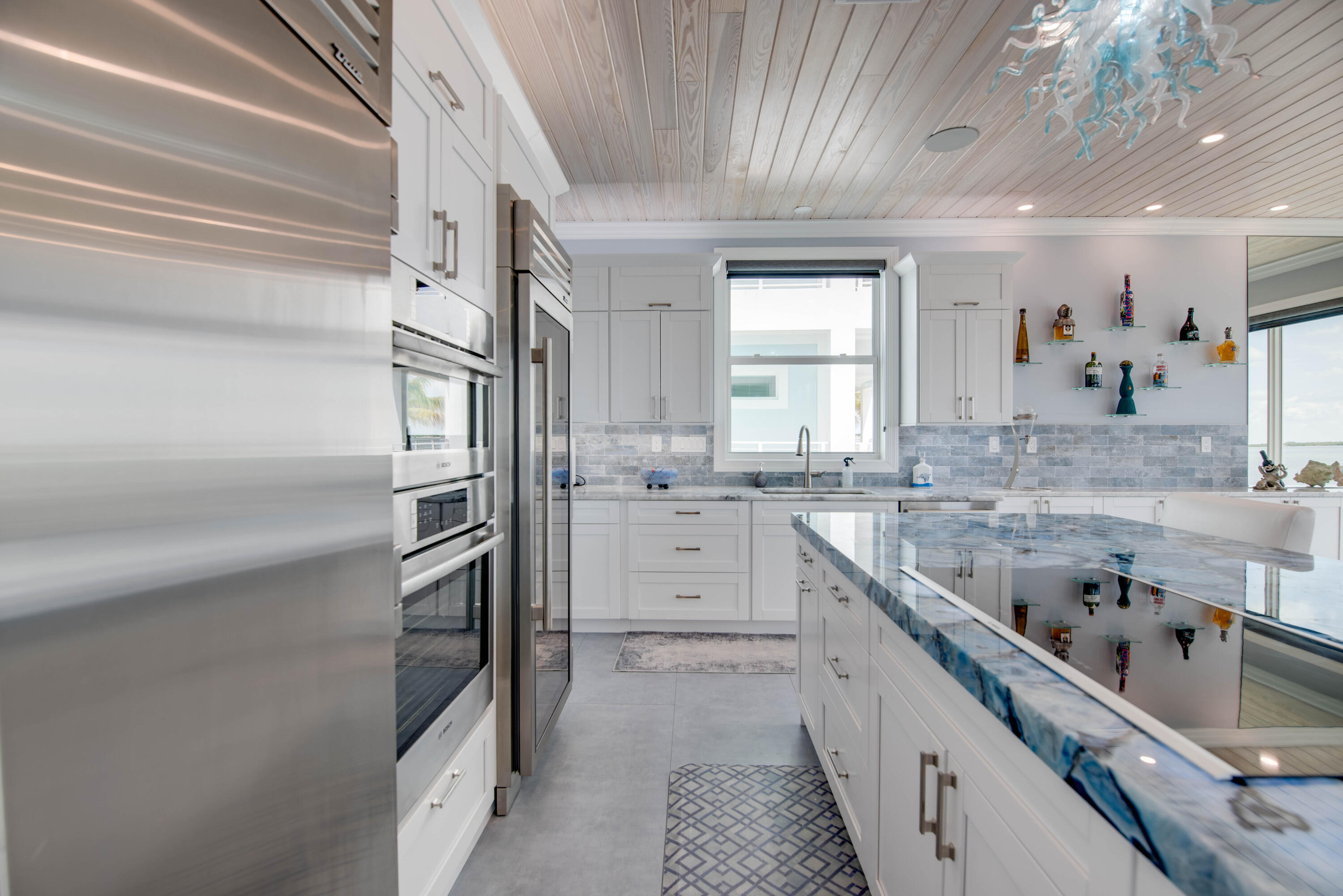 747 La Fitte Road Summerland Key, FL 33042 - Photo 79 of 103 a kitchen with granite countertop stainless steel appliances cabinets a sink and a large window