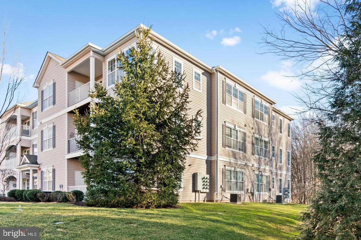 1028 Timberlake Drive Ewing, NJ 08618 - Photo 2 of 10 a view of a big building with a big yard and plants