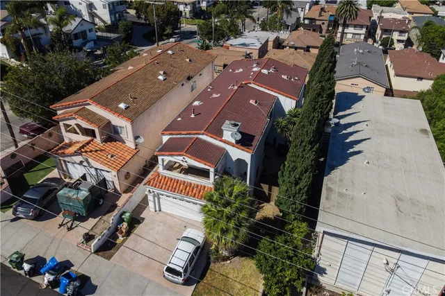 an aerial view of a house with a yard and parking spaces