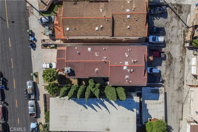 an aerial view of a house with a yard and large tree