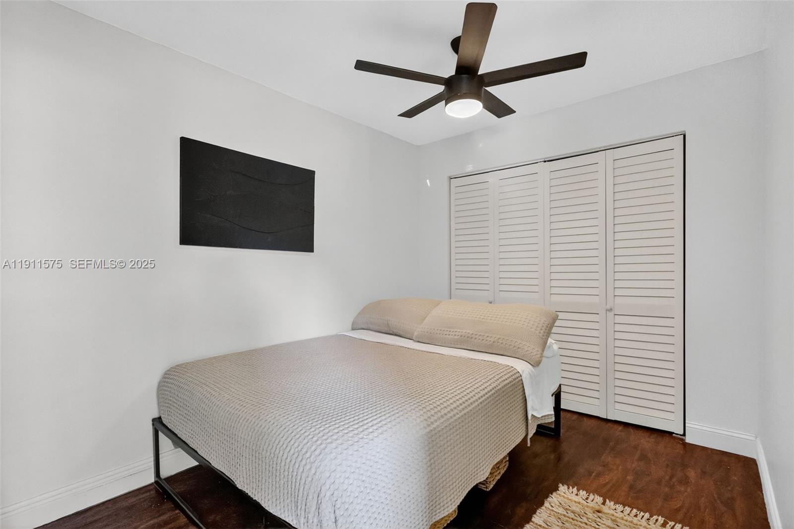 765 Northwest 46th Street Miami, FL 33127 - Photo 12 of 40 a bedroom with a bed and a flat screen tv