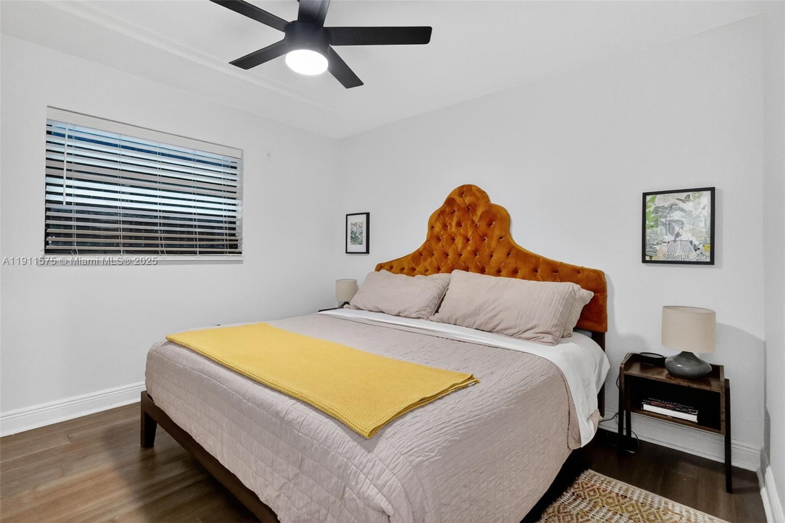 765 Northwest 46th Street Miami, FL 33127 - Photo 18 of 40 a bedroom with a bed and wooden floor