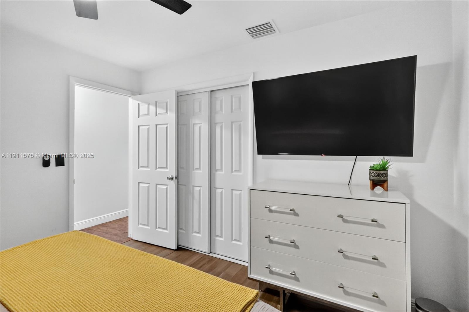 765 Northwest 46th Street Miami, FL 33127 - Photo 19 of 40 a bedroom with a bed and flat screen tv