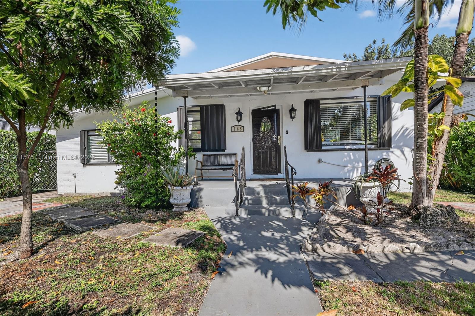 765 Northwest 46th Street Miami, FL 33127 - Photo 2 of 40 a front view of a house with garden
