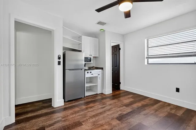 a kitchen with stainless steel appliances granite countertop a refrigerator and a stove top oven