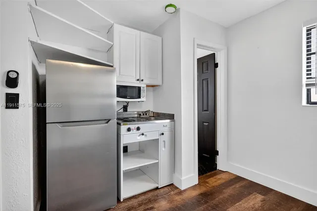 a kitchen with stainless steel appliances a refrigerator and cabinets