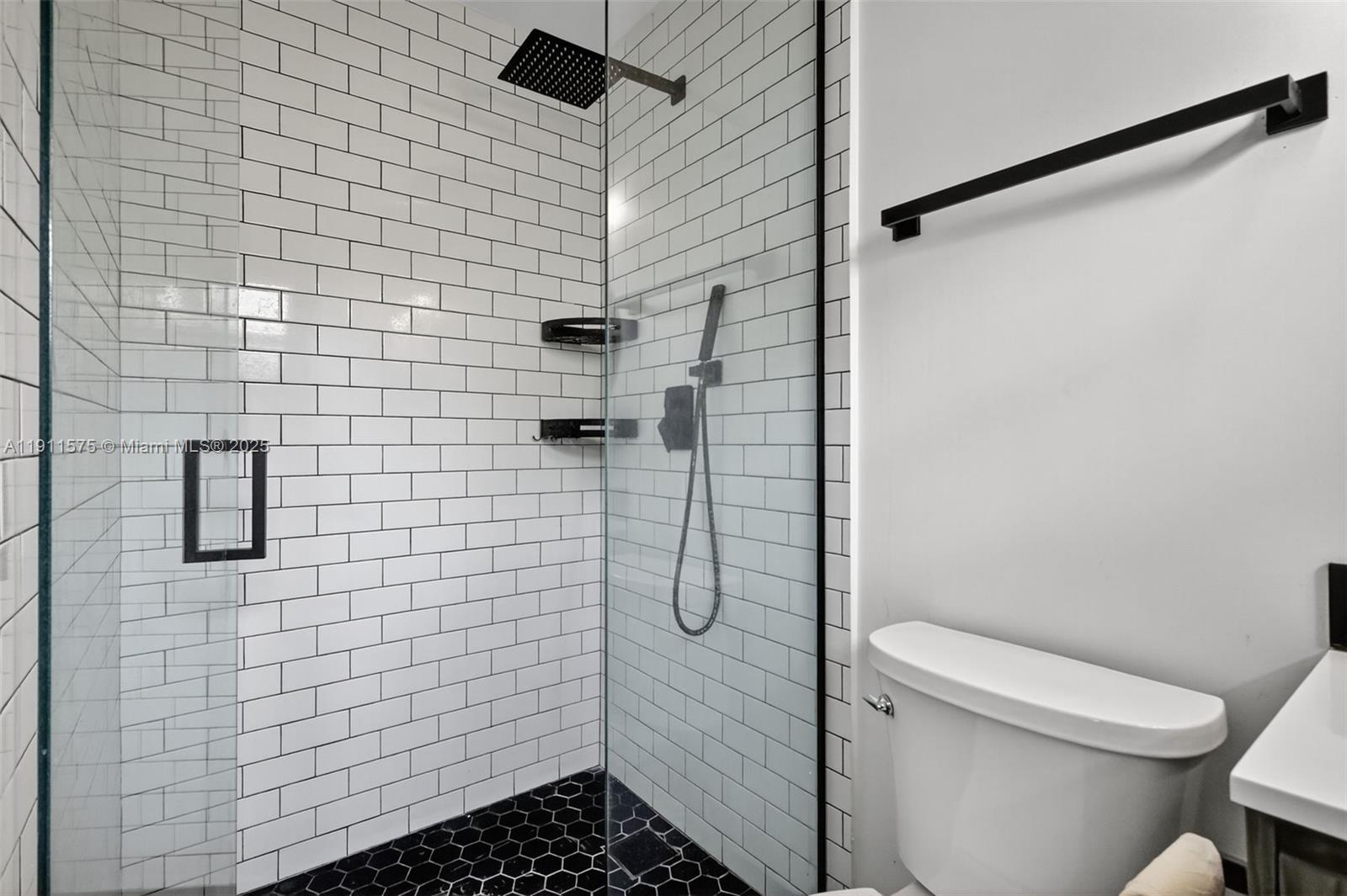 765 Northwest 46th Street Miami, FL 33127 - Photo 27 of 40 a bathroom with a toilet and a shower