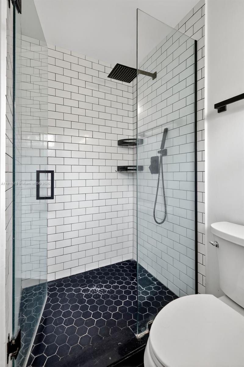 765 Northwest 46th Street Miami, FL 33127 - Photo 29 of 40 a bathroom with a toilet and a shower