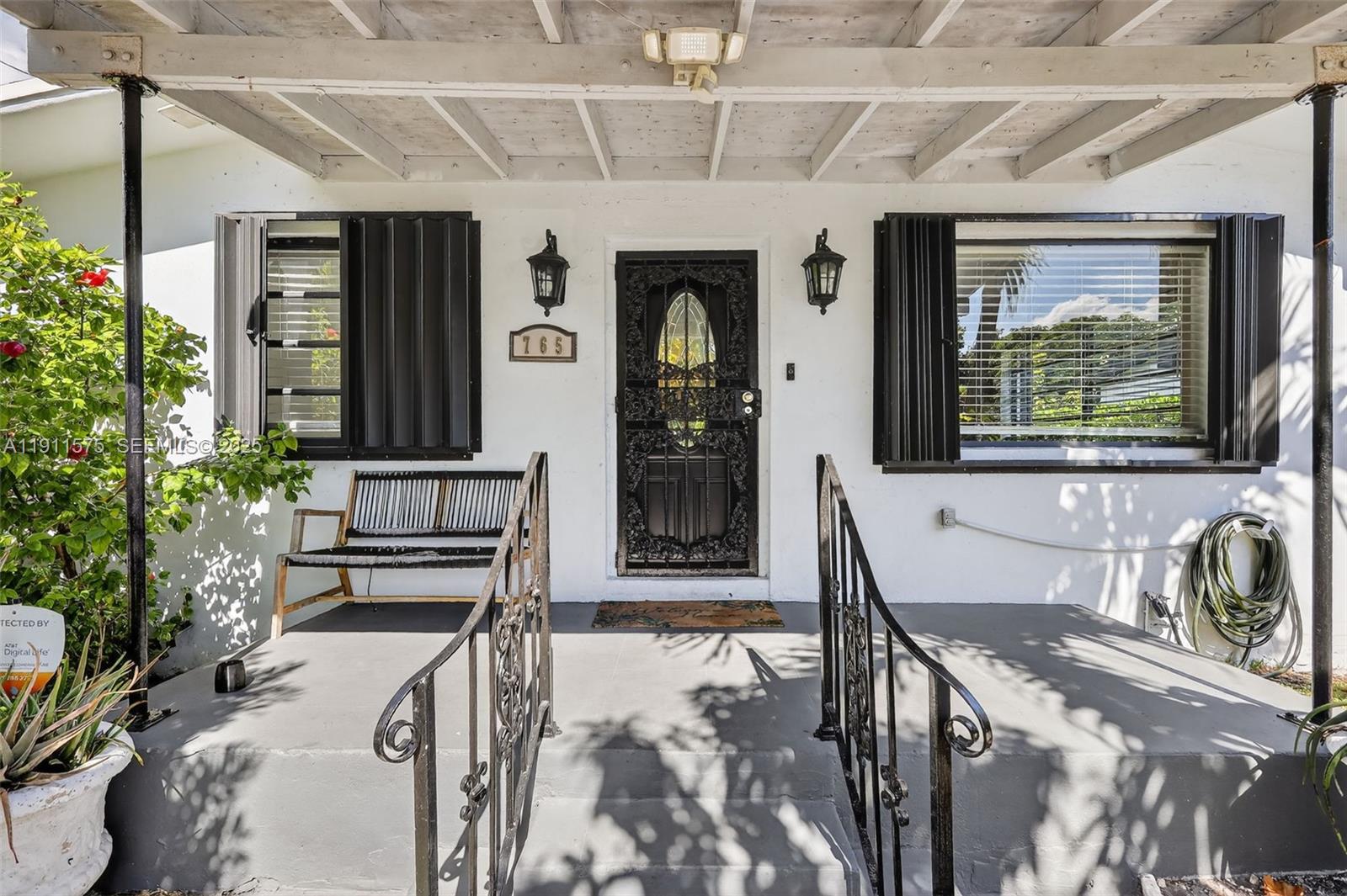 765 Northwest 46th Street Miami, FL 33127 - Photo 3 of 40 a view of a hallway with a dining table and chairs
