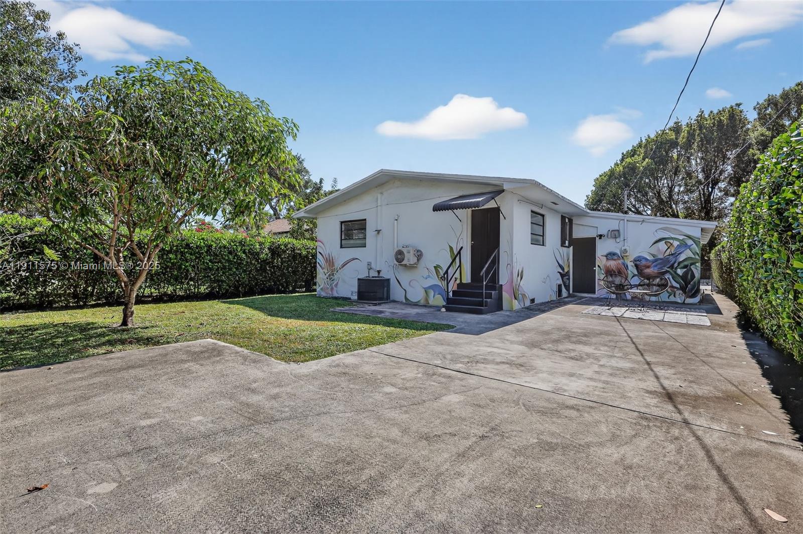 765 Northwest 46th Street Miami, FL 33127 - Photo 35 of 40 a view of a house with backyard and a tree