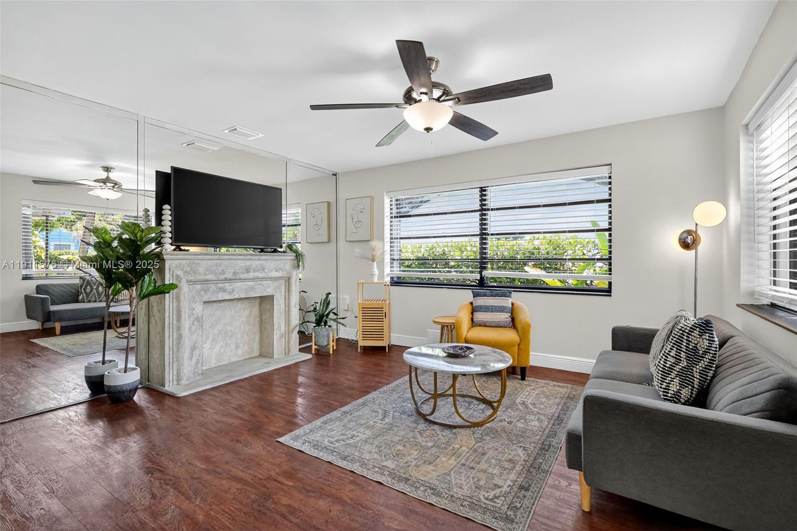 765 Northwest 46th Street Miami, FL 33127 - Photo 4 of 40 a living room with furniture and a flat screen tv
