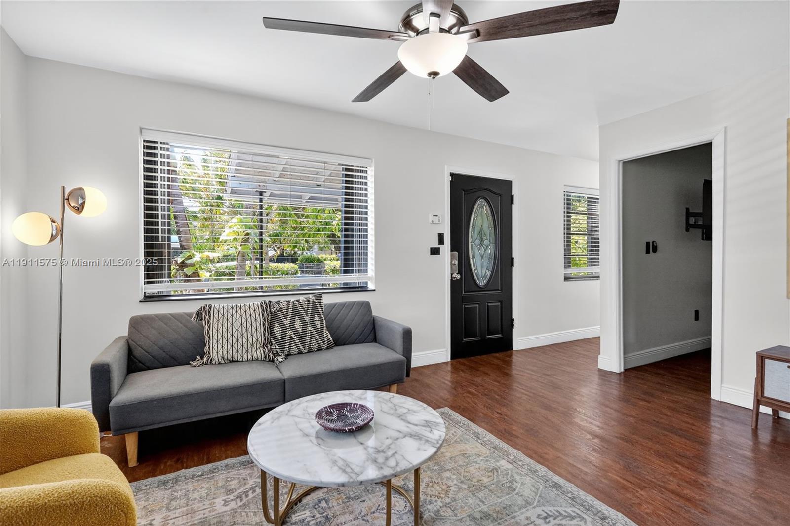 765 Northwest 46th Street Miami, FL 33127 - Photo 7 of 40 a living room with furniture and a large window