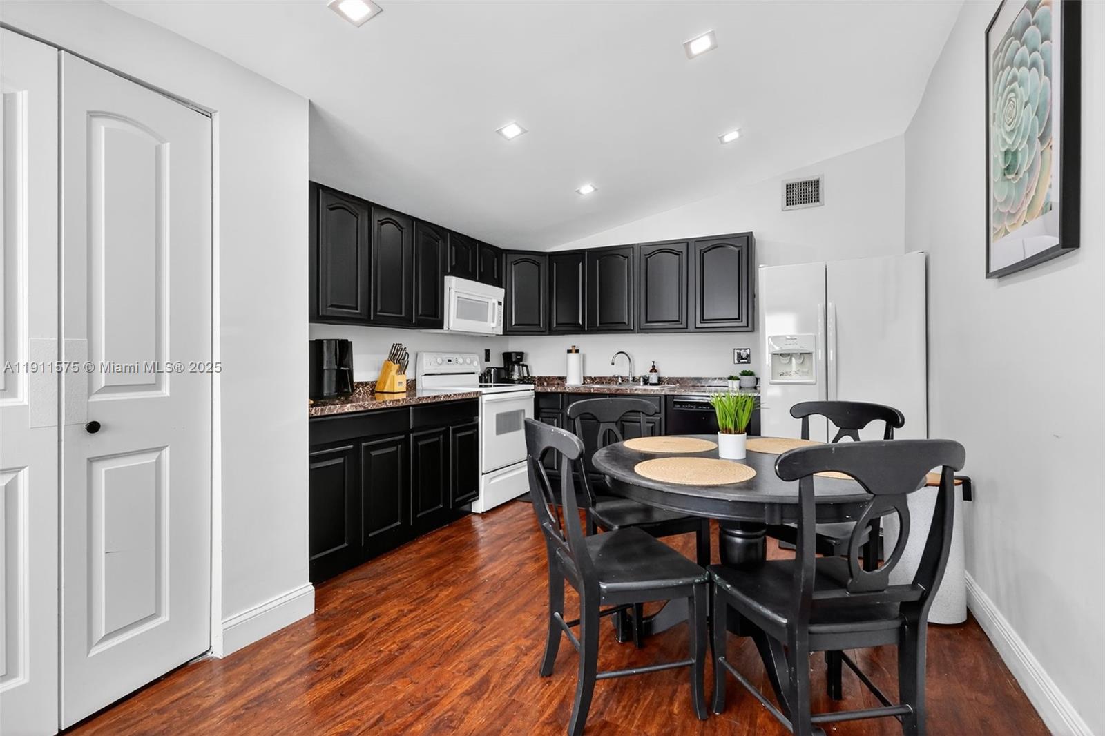 765 Northwest 46th Street Miami, FL 33127 - Photo 8 of 40 a kitchen with granite countertop wooden floors and appliances
