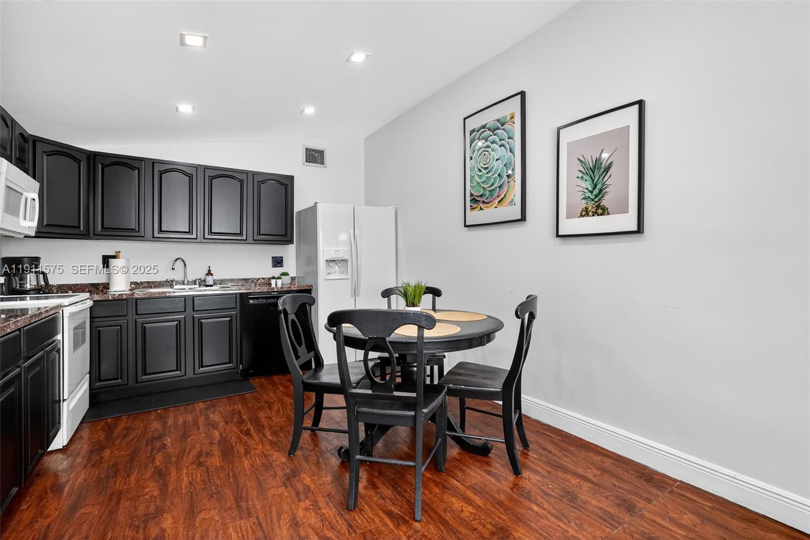 765 Northwest 46th Street Miami, FL 33127 - Photo 9 of 40 a view of kitchen with cabinets and wooden floor