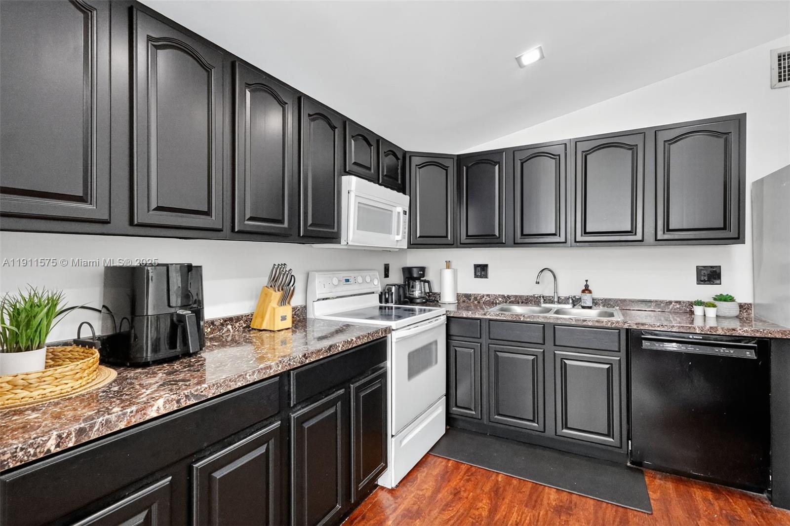 765 Northwest 46th Street Miami, FL 33127 - Photo 10 of 40 a kitchen with granite countertop stainless steel appliances and sink