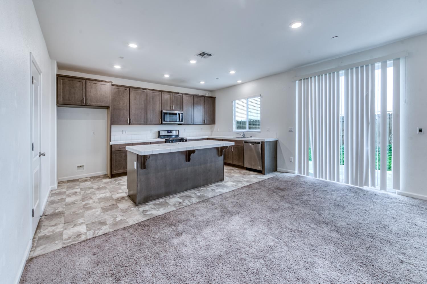 1469 Rinconada Drive Madera, CA 93637 - Photo 17 of 32 a large kitchen with kitchen island a sink stainless steel appliances and cabinets