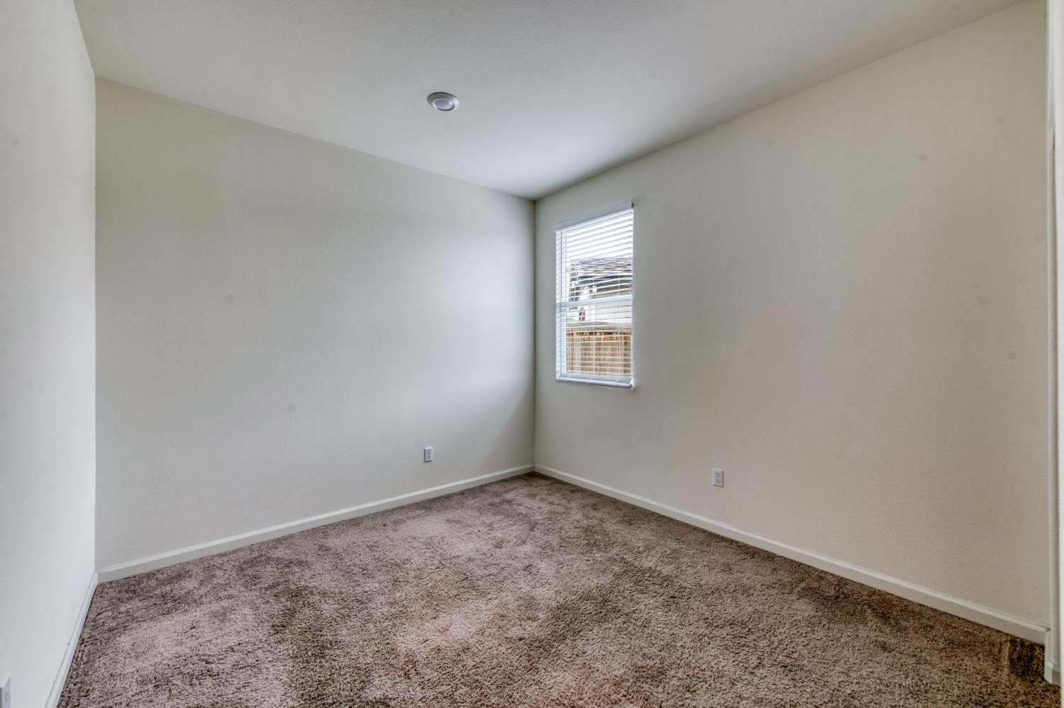 1469 Rinconada Drive Madera, CA 93637 - Photo 22 of 32 an empty room with windows