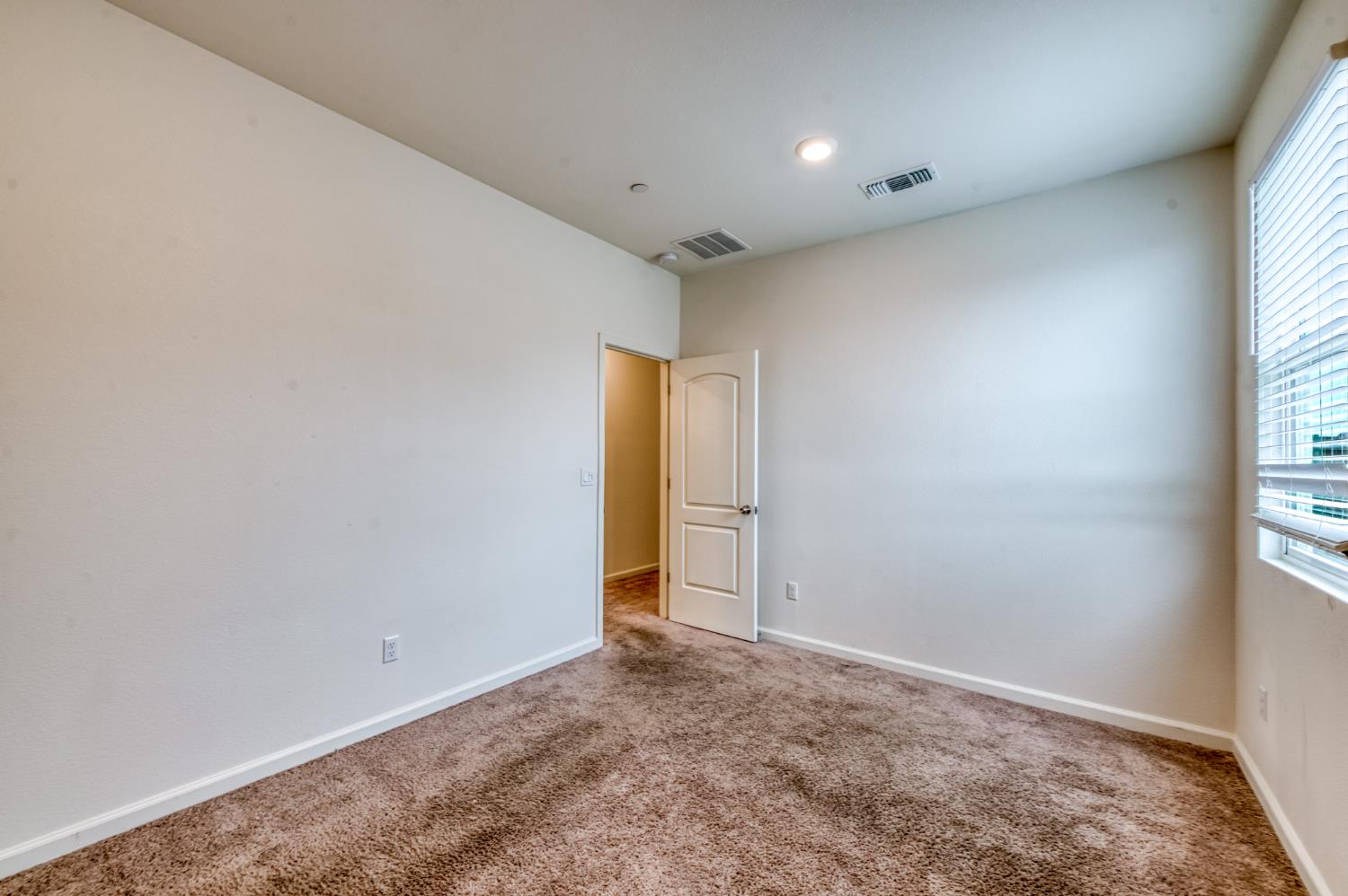 1469 Rinconada Drive Madera, CA 93637 - Photo 23 of 32 an empty room with windows