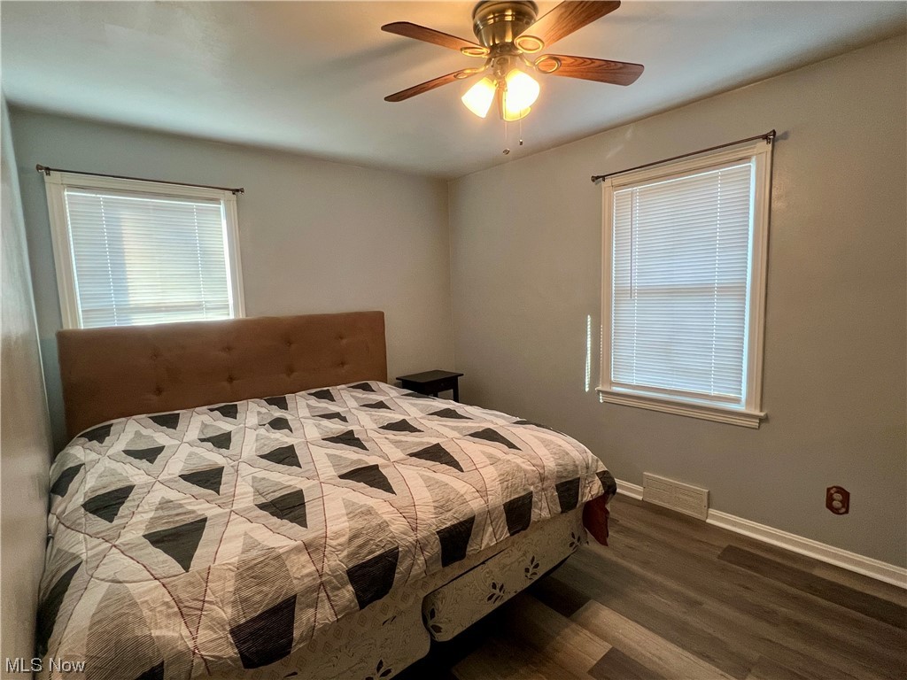 229 Hilliard Road Elyria, OH 44035 - Photo 6 of 28 Bedroom 1 with dark hardwood / wood-style flooring, multiple windows, and ceiling fan