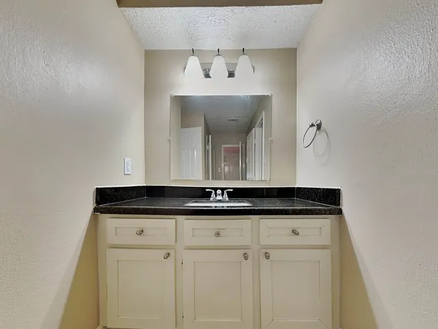 a view of empty room with wooden floor and ceiling fan