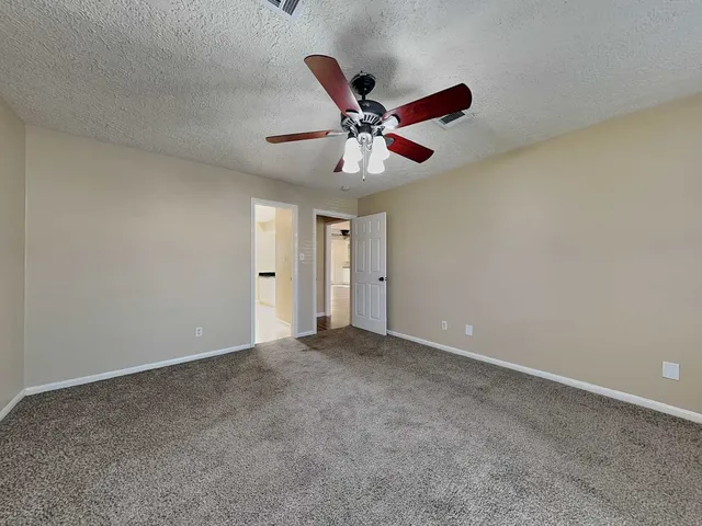 an empty room with a empty space and a ceiling fan