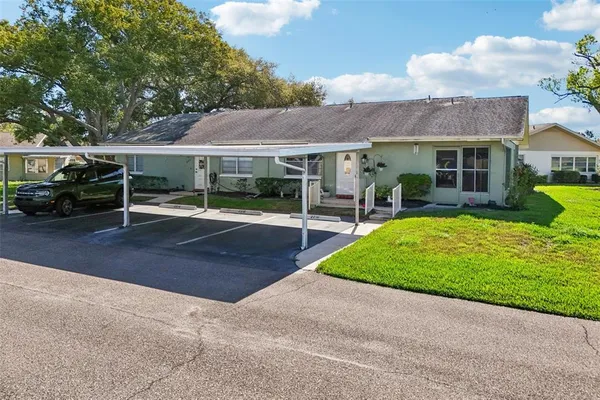 a view of a house with a yard and sitting area