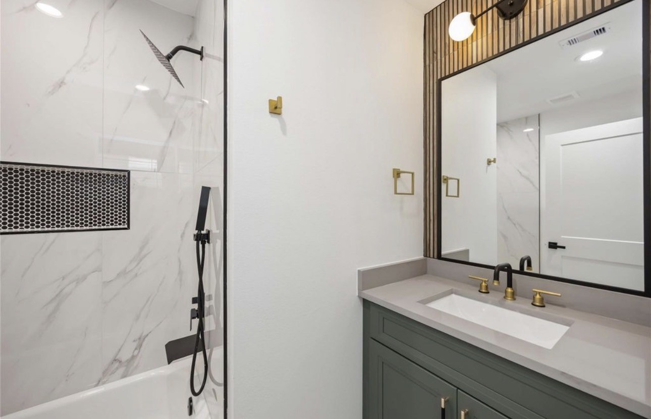 8011 Cora Street, Unit A Houston, TX 77088 - Photo 6 of 14 a bathroom with a granite countertop sink a mirror and a shower