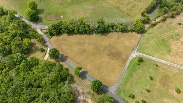 an aerial view of residential house with pool and yard