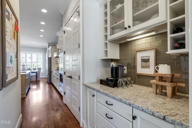 a large kitchen with stainless steel appliances granite countertop a lot of counter space