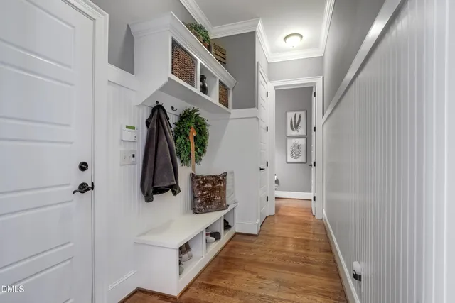 a view of a hallway with wooden floor and stairs
