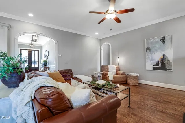 a living room with furniture potted plant and a chandelier