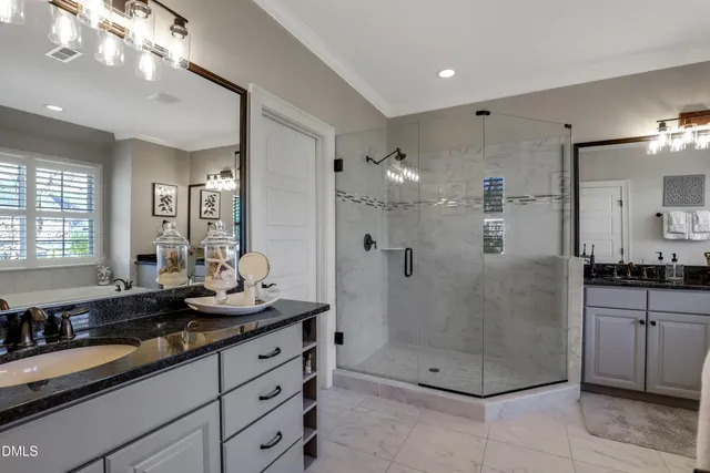 a bathroom with double vanity sinks a vanity and a mirror