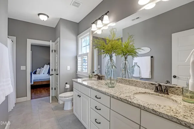 a spacious bedroom with a bed and a painting on the wall