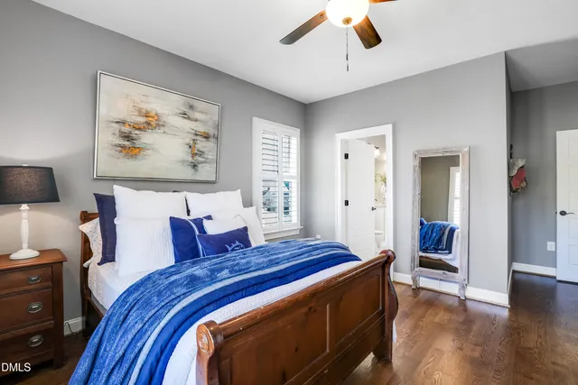 a bedroom with a bed dresser and a window