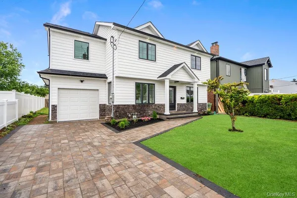 a view of a house with a yard and plants