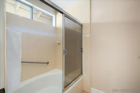 a bathroom with a bathtub and a shower