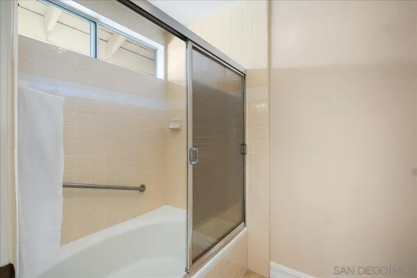 a bathroom with a bathtub and a shower