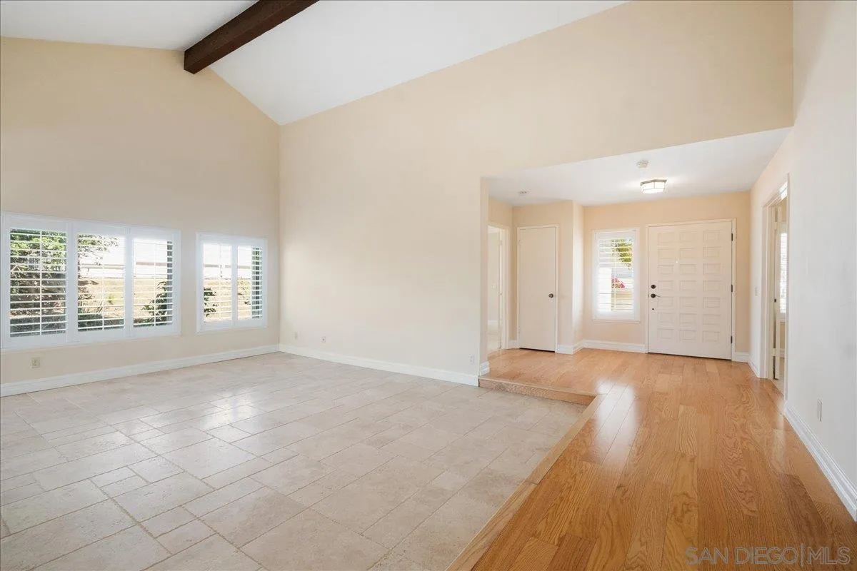 17526 St Andrews Drive Poway, CA 92064 - Photo 13 of 55 a view of an empty room with wooden floor and a window