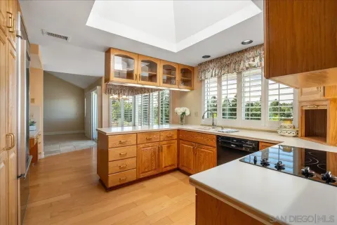 a kitchen with granite countertop sink stove and cabinets