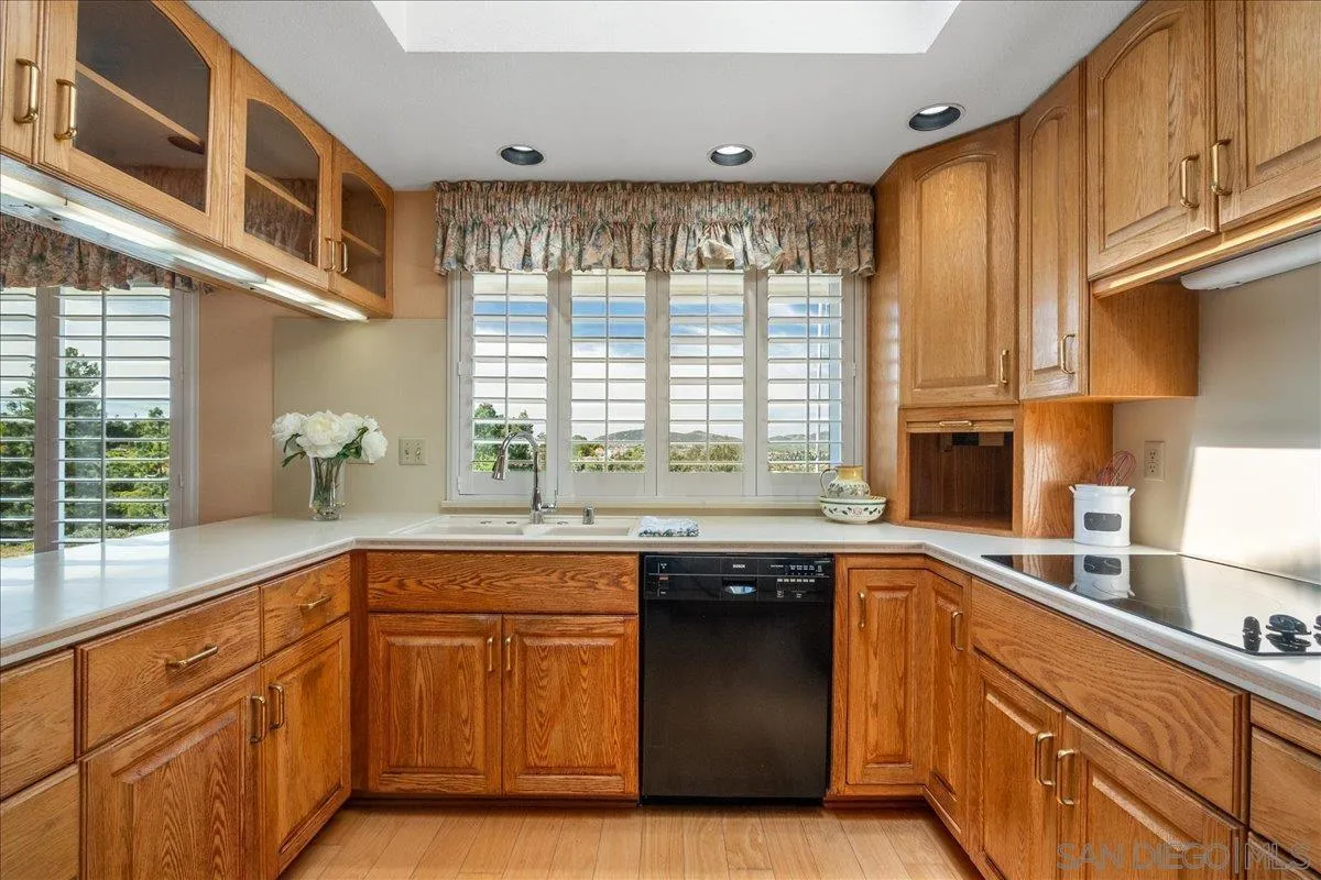 17526 St Andrews Drive Poway, CA 92064 - Photo 18 of 55 a kitchen with granite countertop sink stove and cabinets
