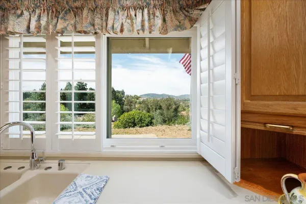 a kitchen with stainless steel appliances granite countertop a sink and a stove