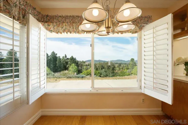 a view of an empty room with a fireplace and a window