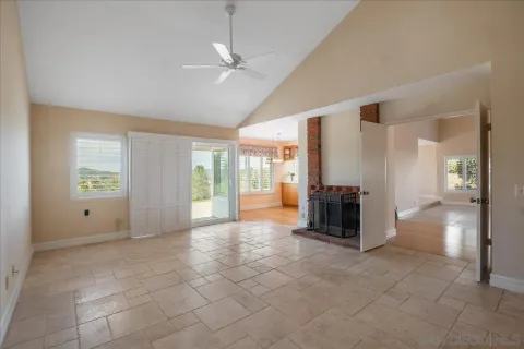 a view of a livingroom with a ceiling fan and window