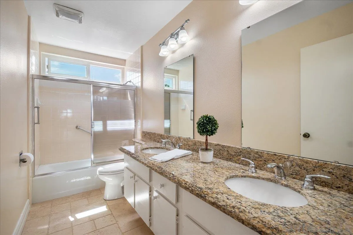 17526 St Andrews Drive Poway, CA 92064 - Photo 40 of 55 a bathroom with a granite countertop sink and a mirror