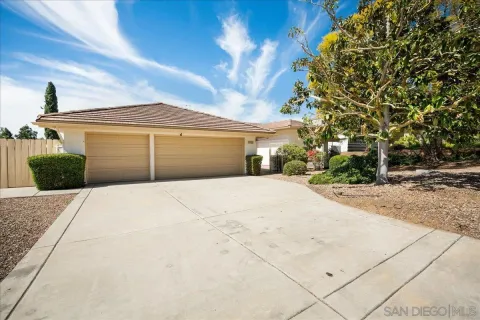 a view of a house with a yard and garage