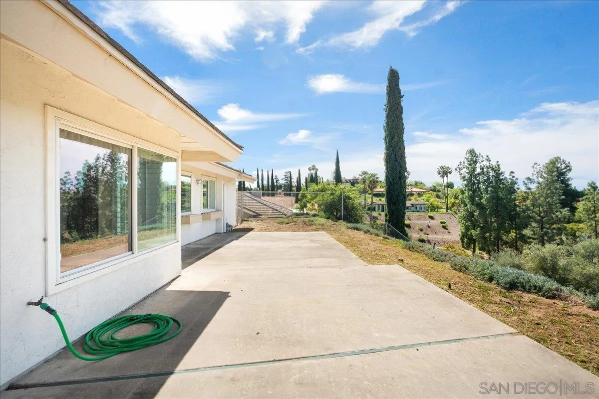 17526 St Andrews Drive Poway, CA 92064 - Photo 45 of 55 a view of a patio with lawn chairs floor to ceiling window and tree