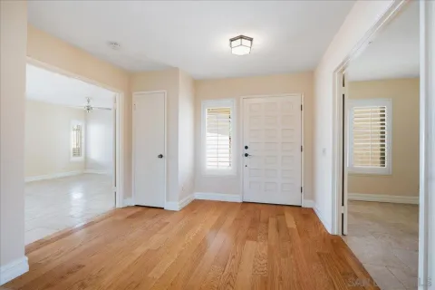 a view of a room with wooden floor and a bathroom